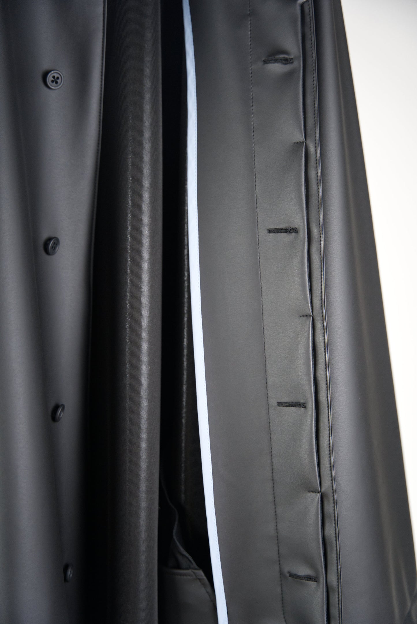 blue piping inside the matt black bal collar coat in cactus leather