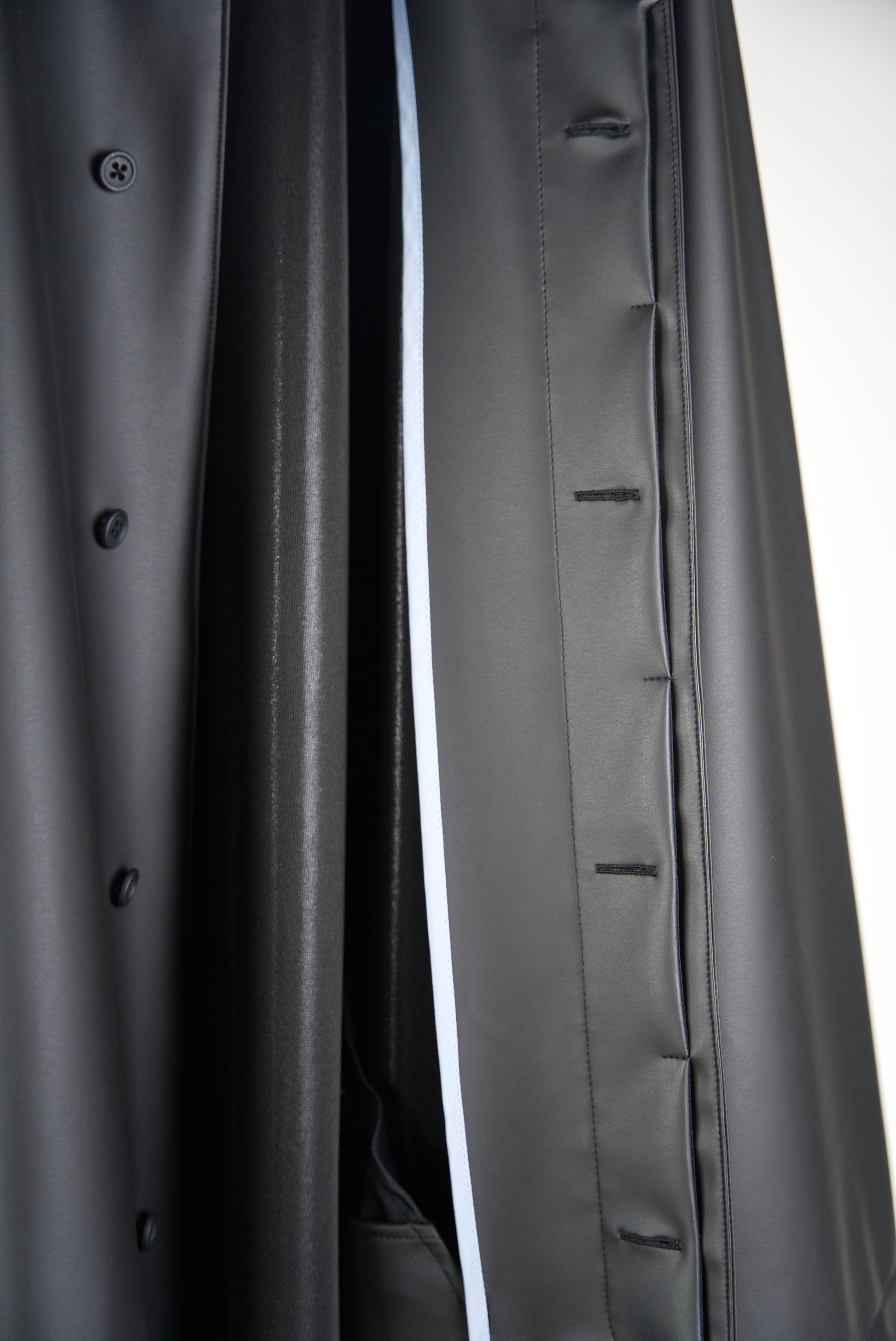 blue piping inside the matt black bal collar coat in cactus leather