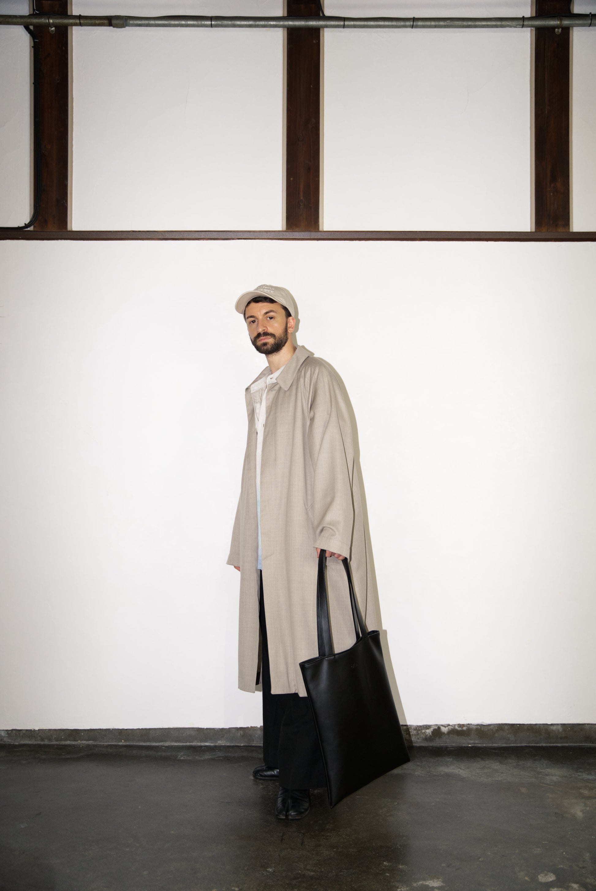 male model carrying the VOID Tote Bag in Cactus Leather