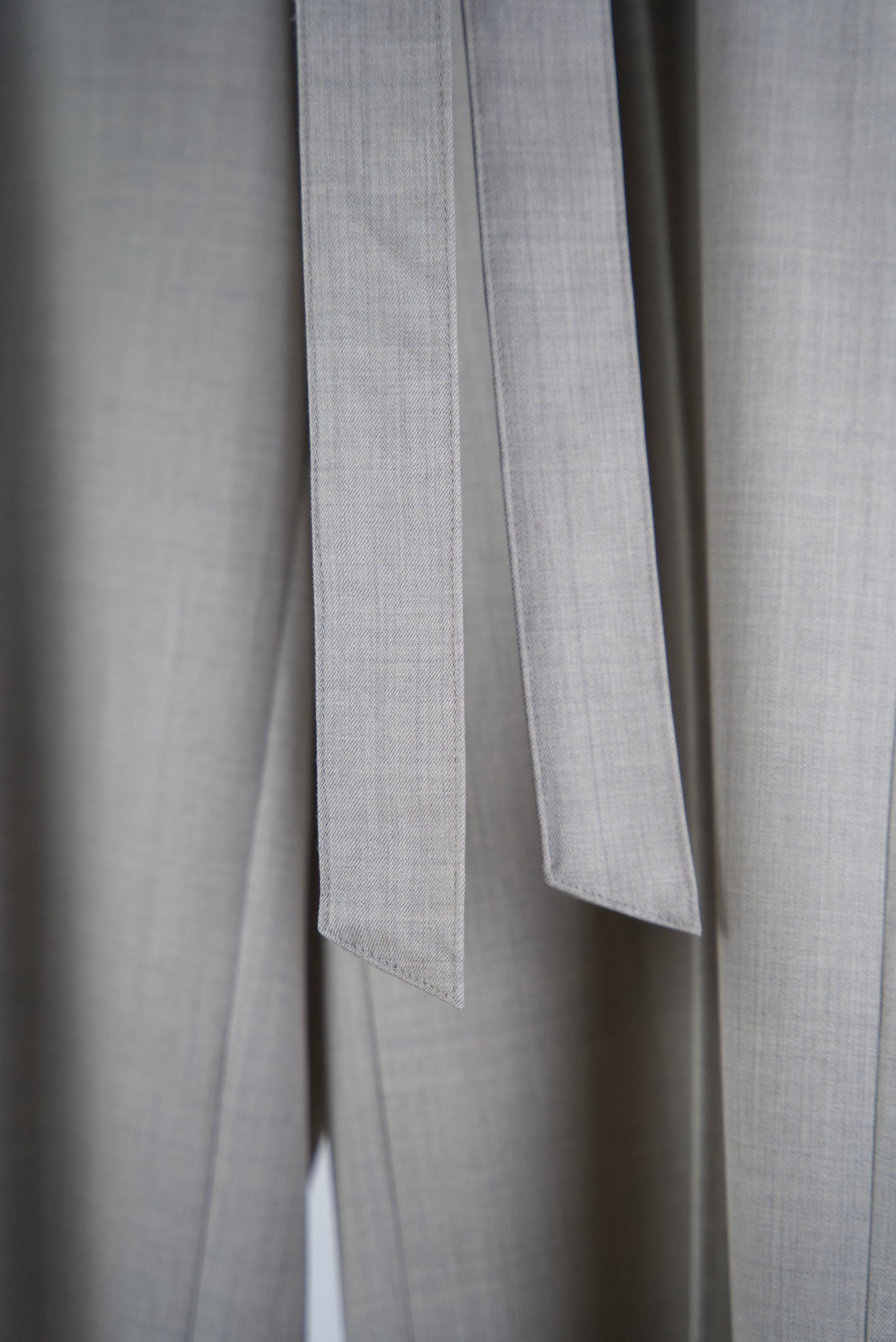 long wool belt of the Belted Wide Flared Trousers in Wool