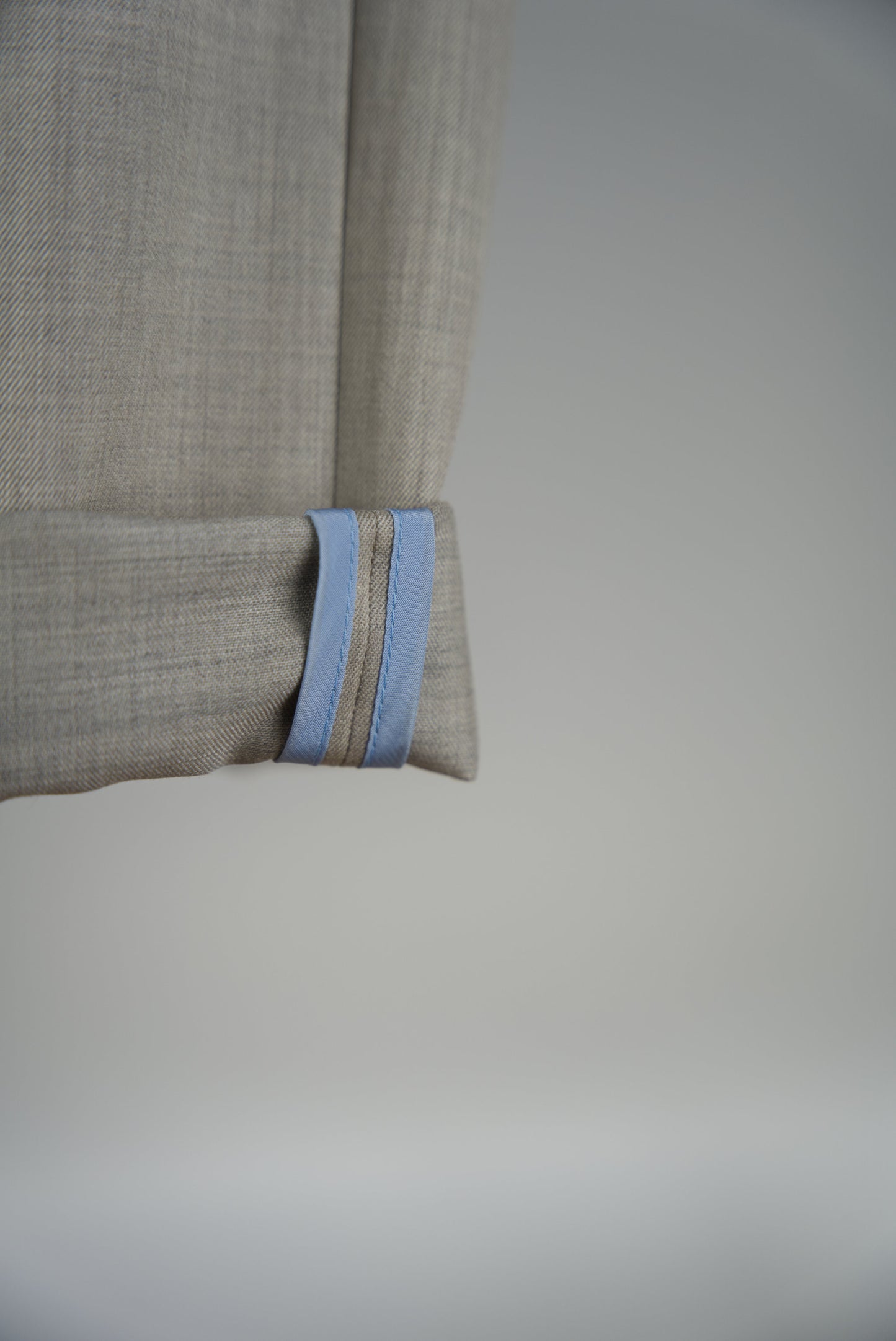 blue cupro piping of the Belted Wide Flared Trousers in Wool