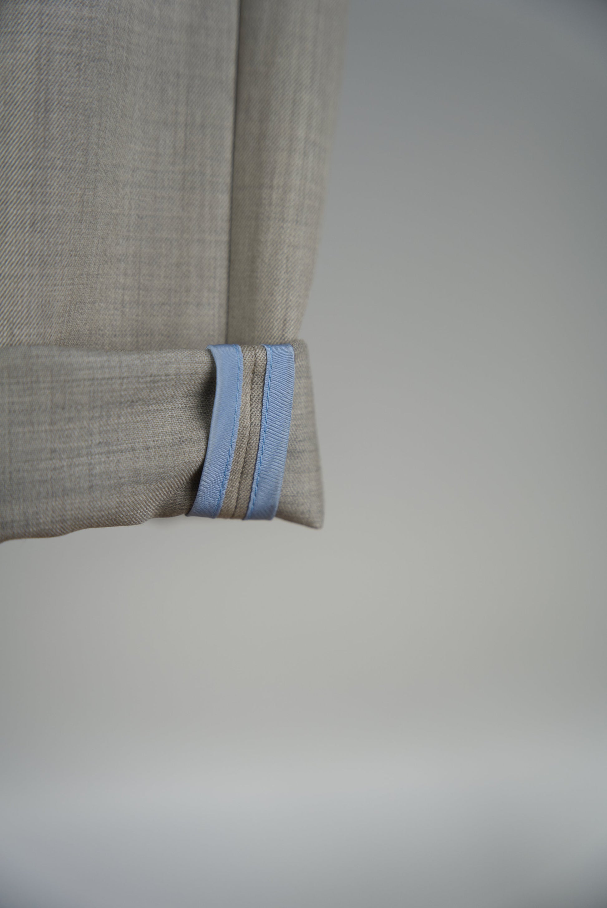 blue cupro piping of the Belted Wide Flared Trousers in Wool