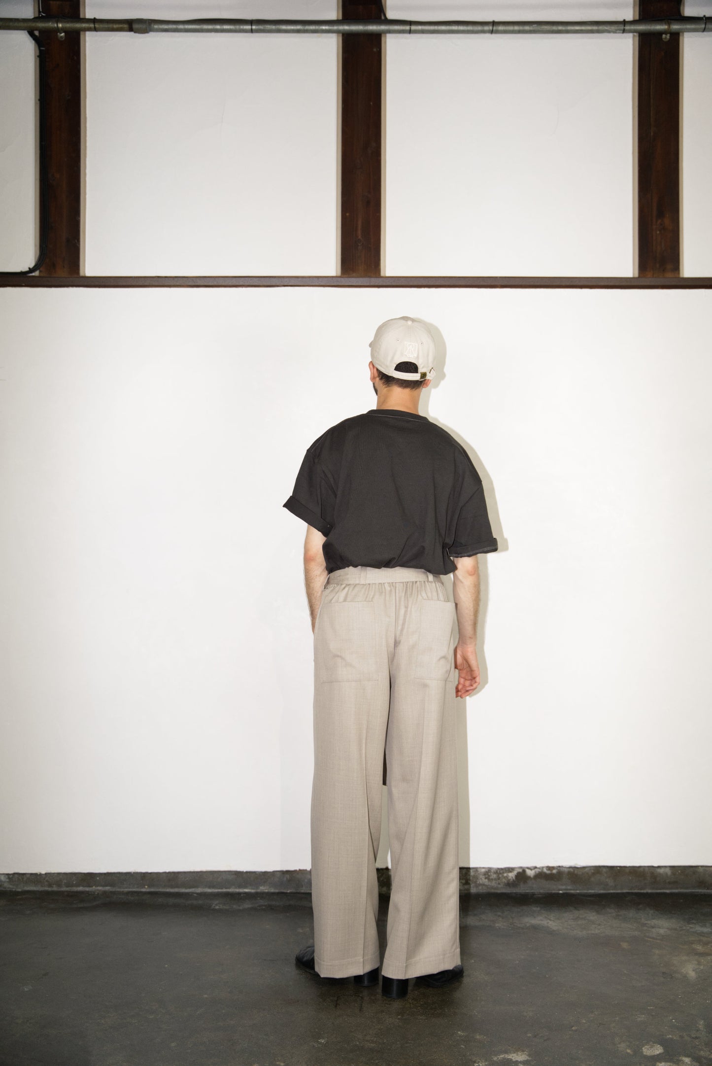 back side of the Belted Wide Flare Trousers in Wool