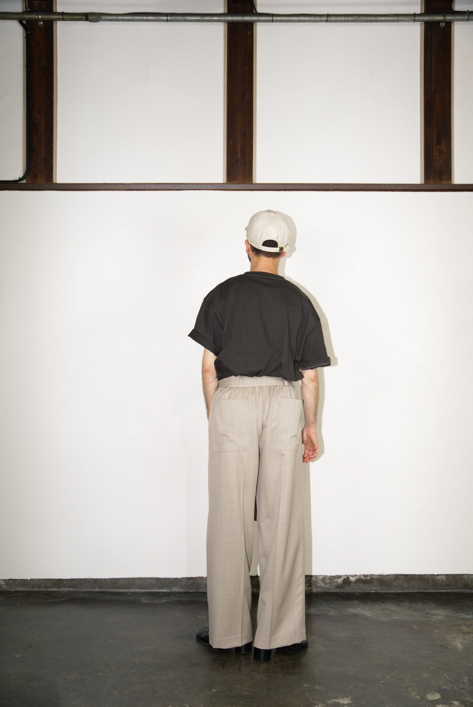 back side of the Belted Wide Flare Trousers in Wool