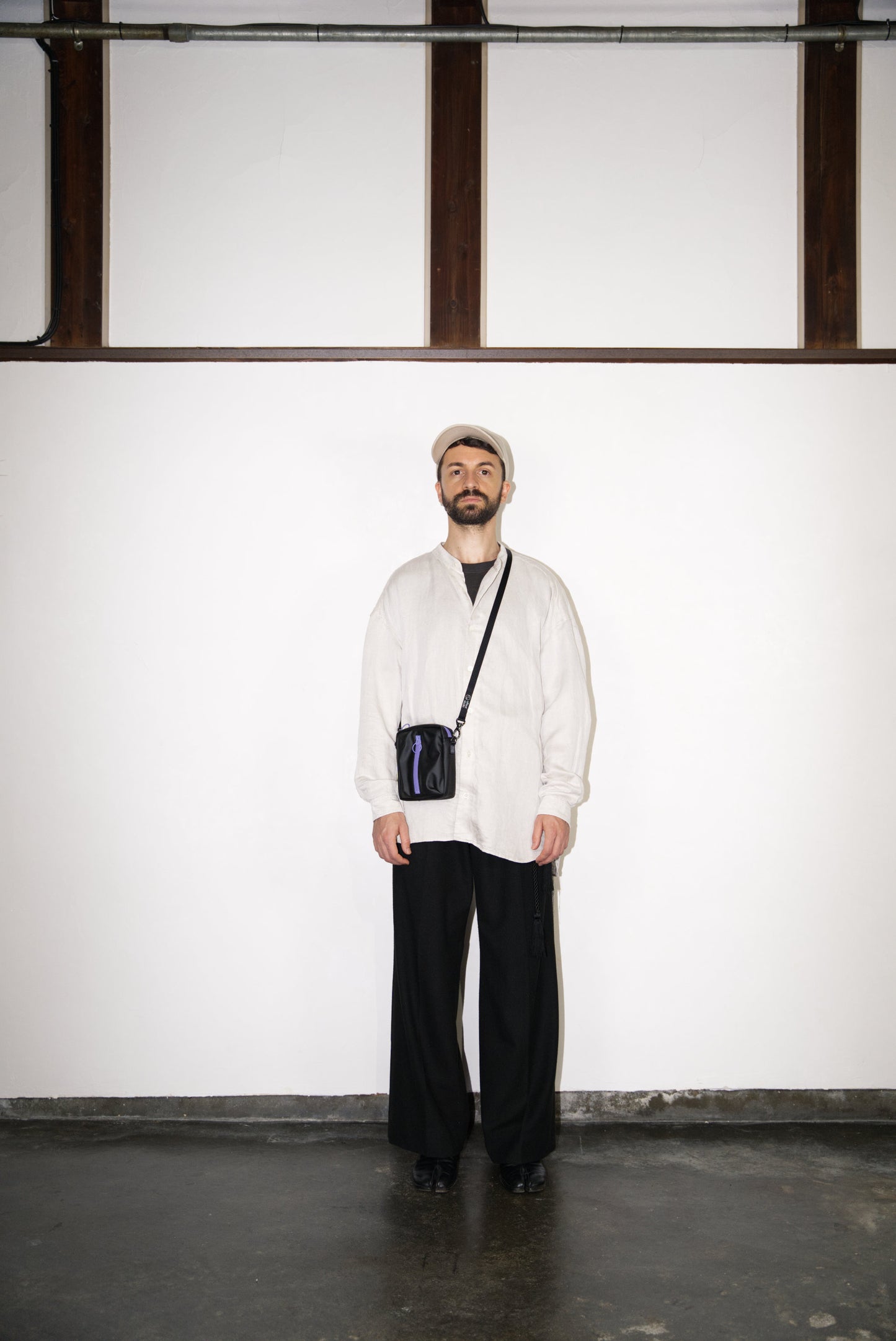 male model wearing the purple BOX Cactus Leather Mini Bag
