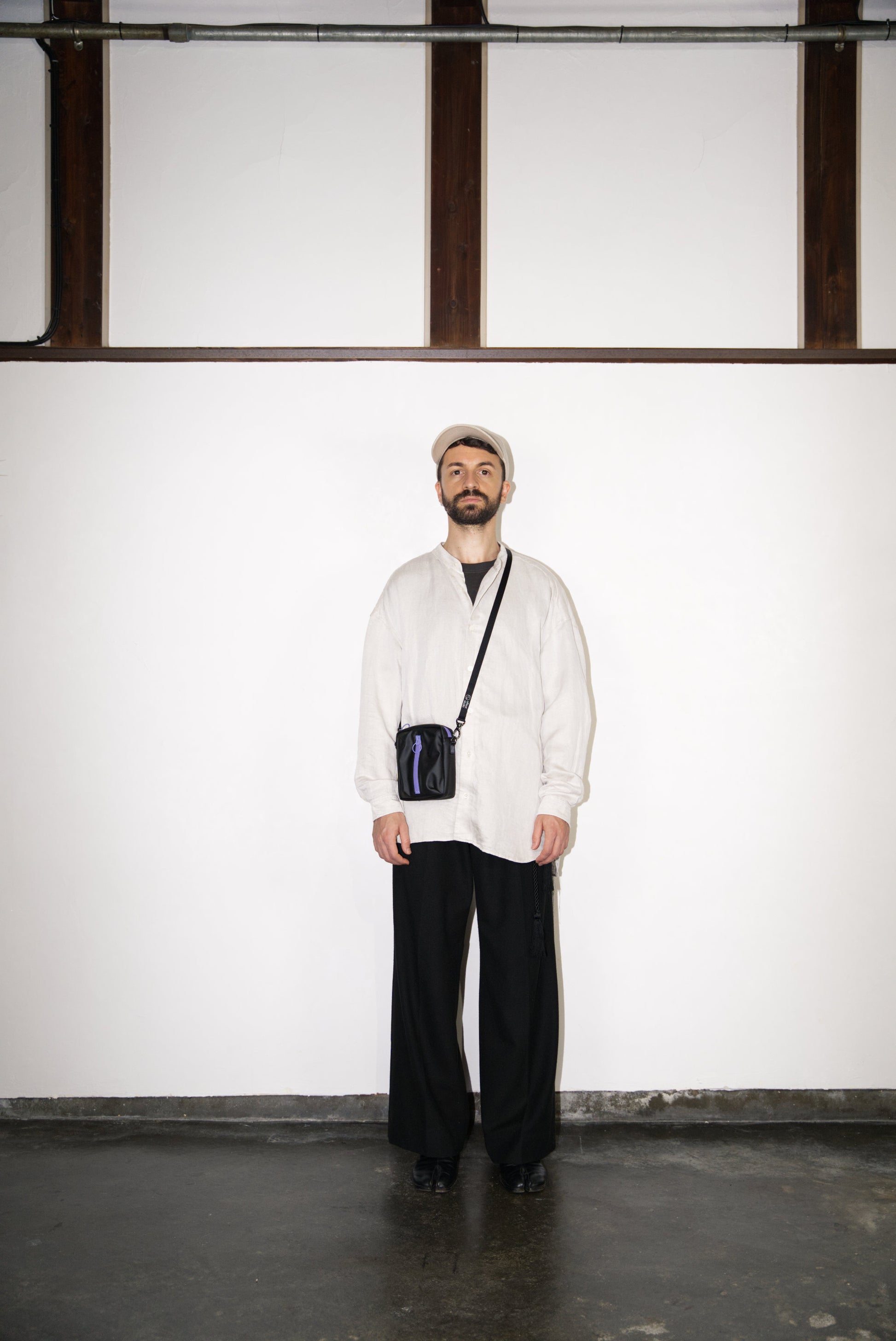 male model wearing the purple BOX Cactus Leather Mini Bag