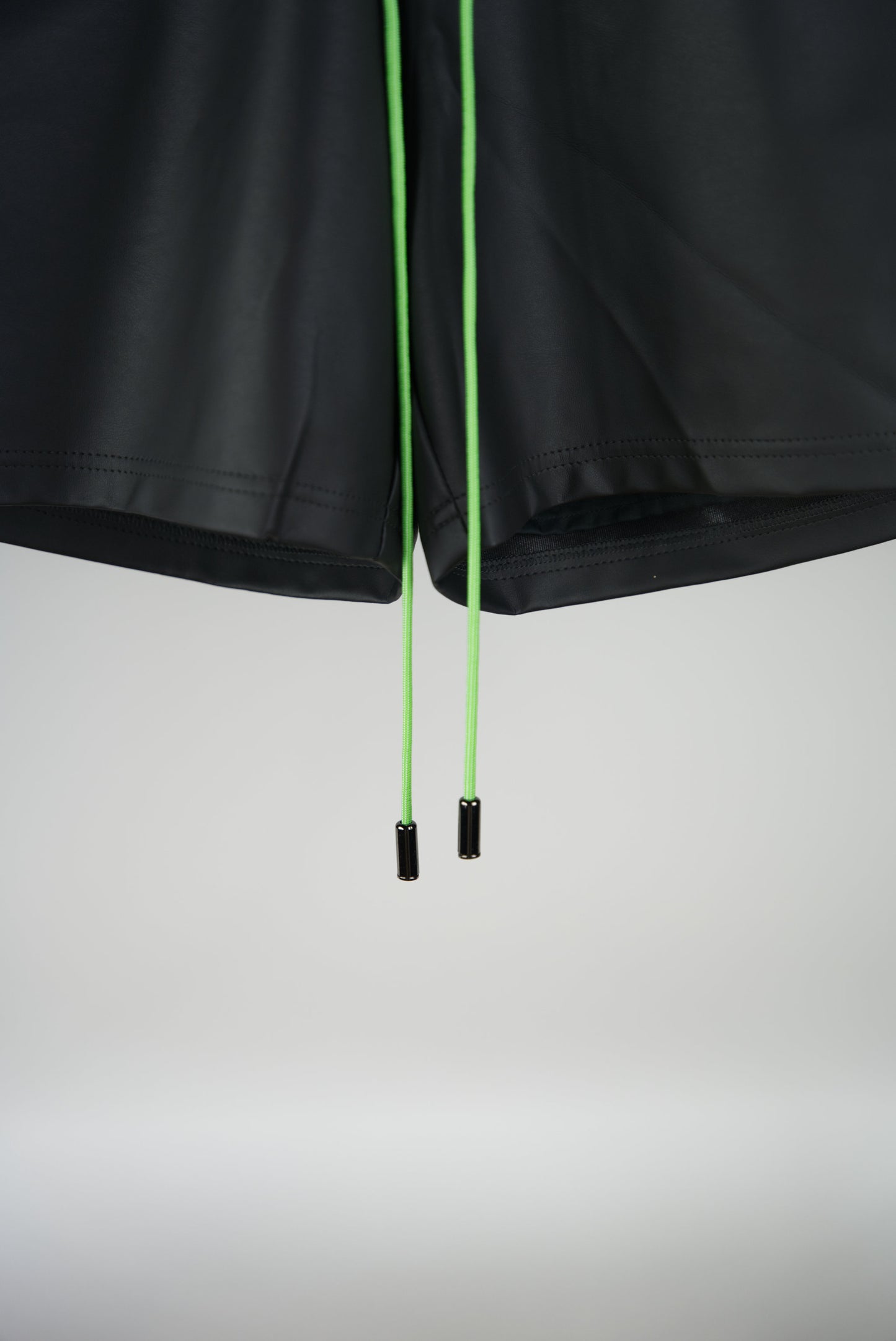 neon green paracord of the Hand-Stitched SCENE Cactus Leather Shorts