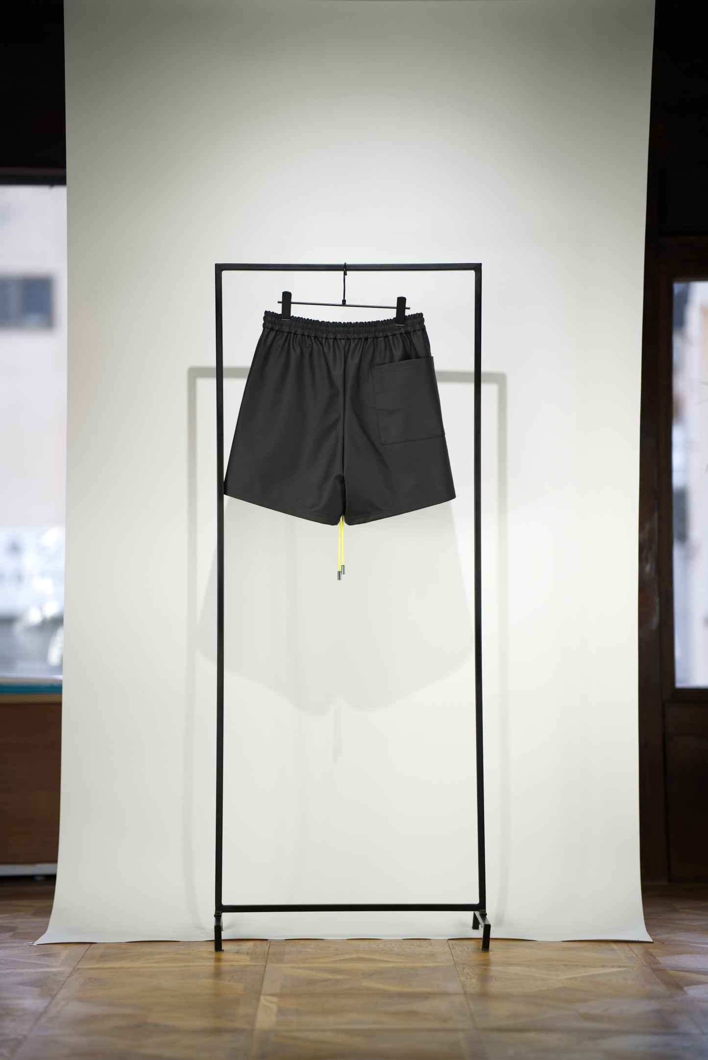 back side of the the hand-stitched scene cactus leather shorts in neon yellow