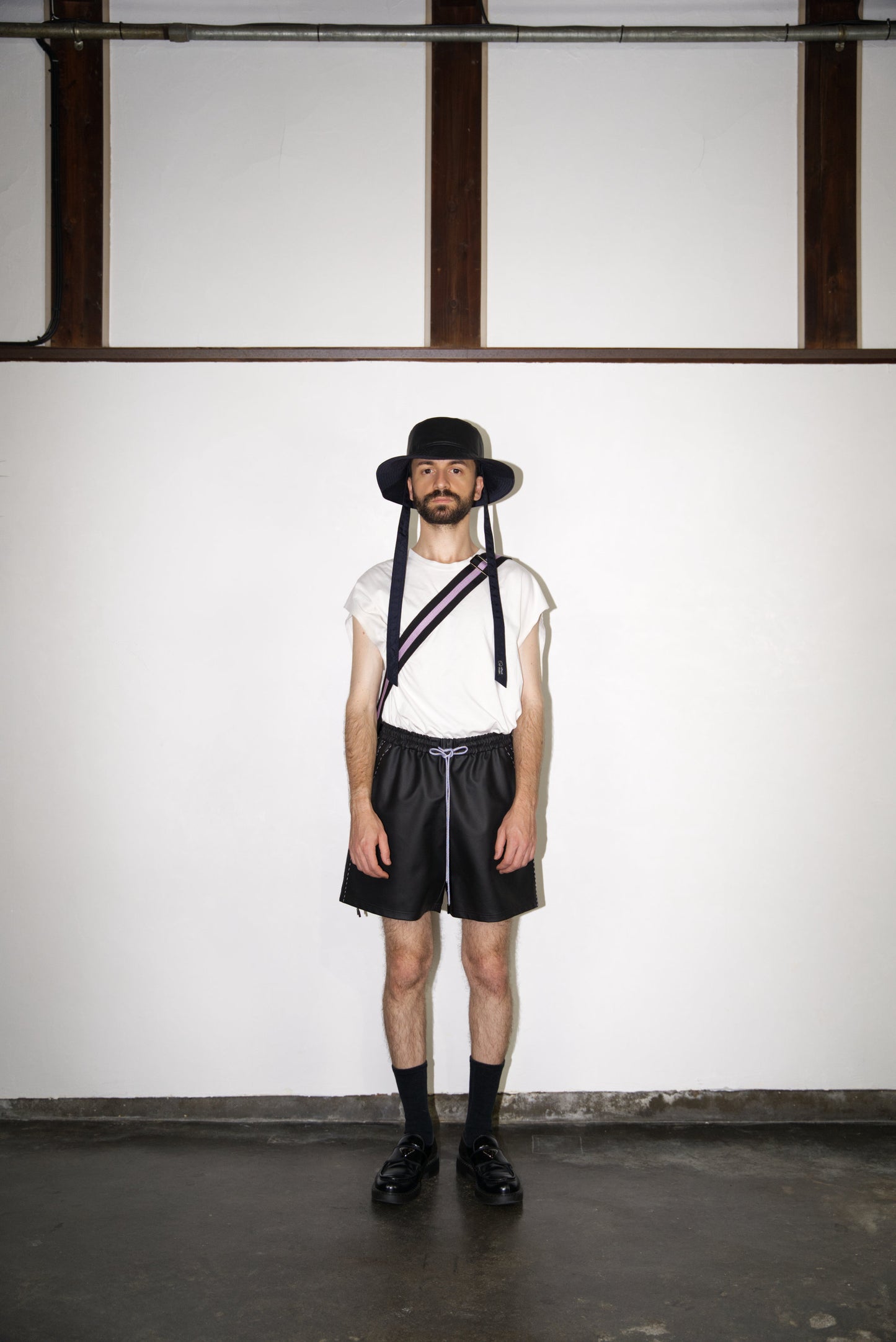 male model wearing the light purple hand-stitched scene cactus leather shorts