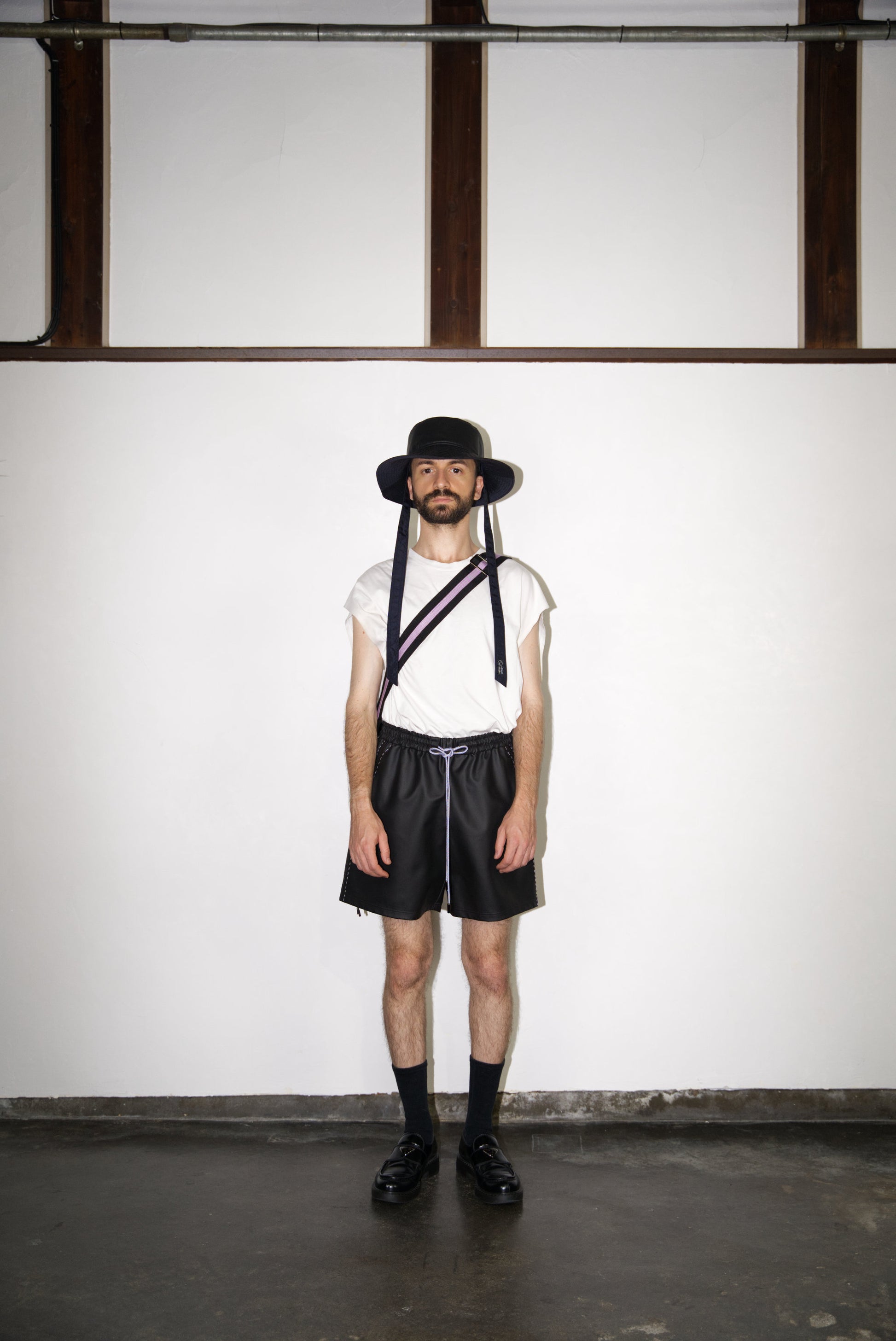 male model wearing the light purple hand-stitched scene cactus leather shorts