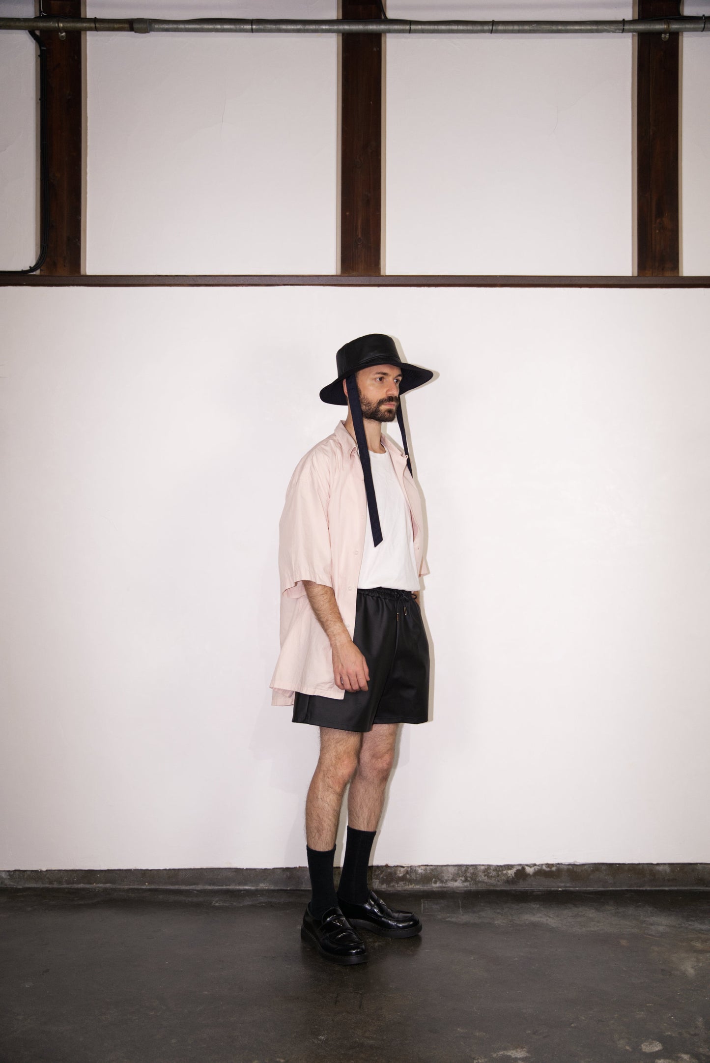 SCENE Cactus Leather Shorts on male mode wearing hat and shirt looking to the side