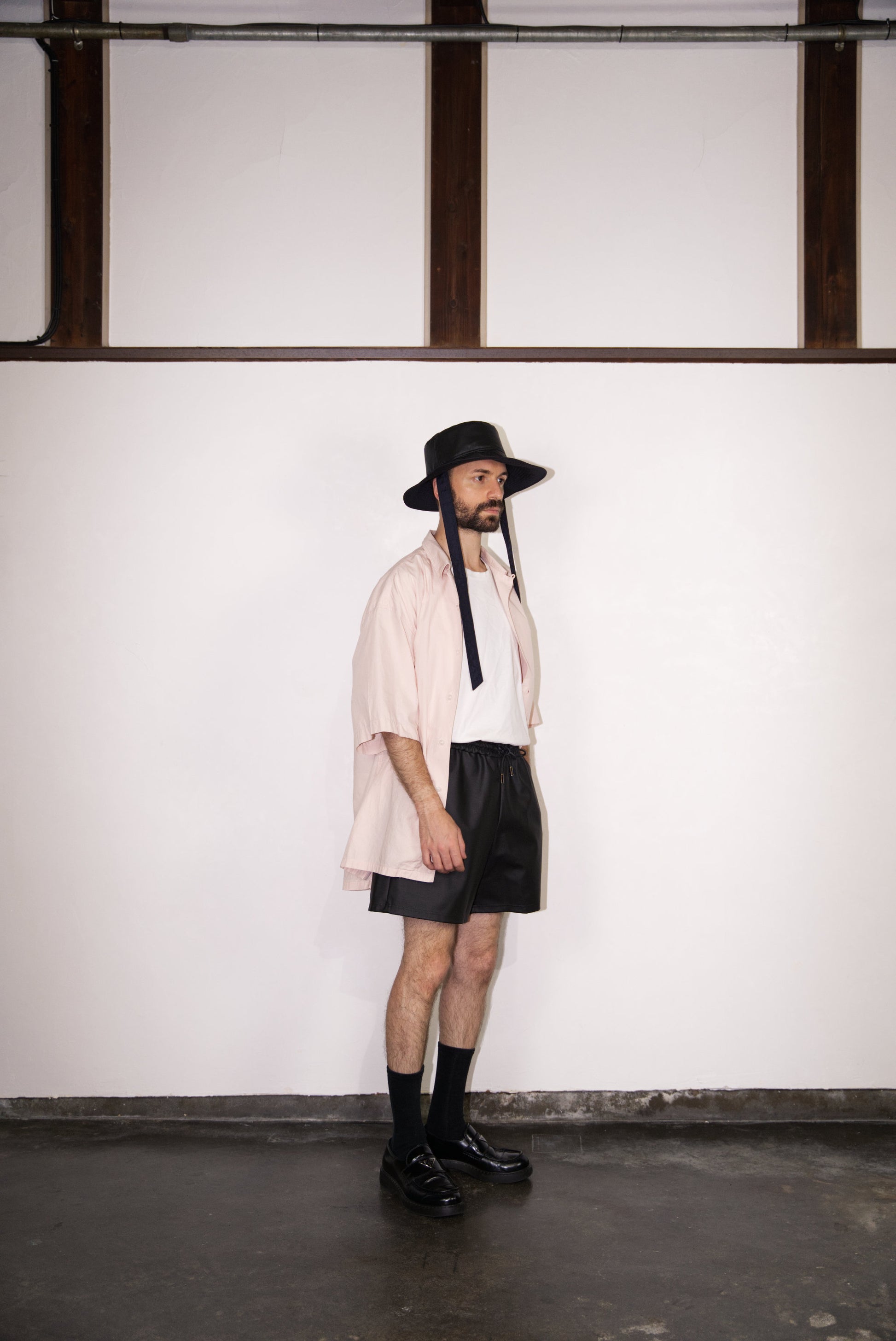 SCENE Cactus Leather Shorts on male mode wearing hat and shirt looking to the side