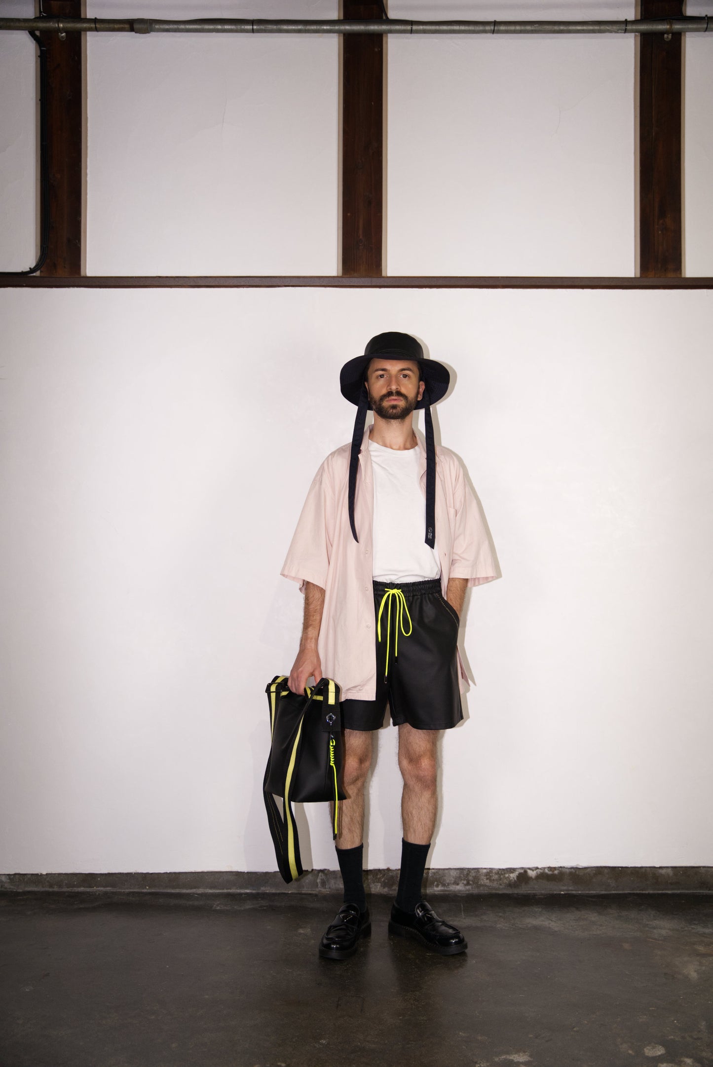 male model wearing the hand-stitched scene cactus leather shorts in neon yellow