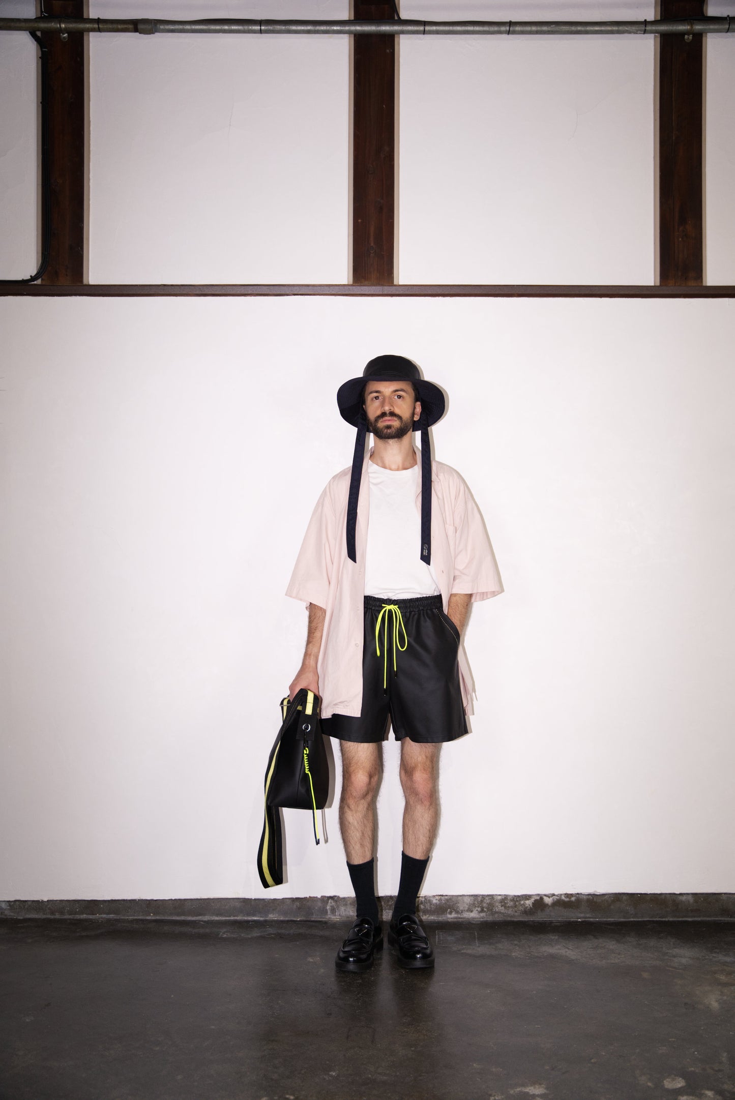 the hand-stitched scene cactus leather shorts in neon yellow on male model