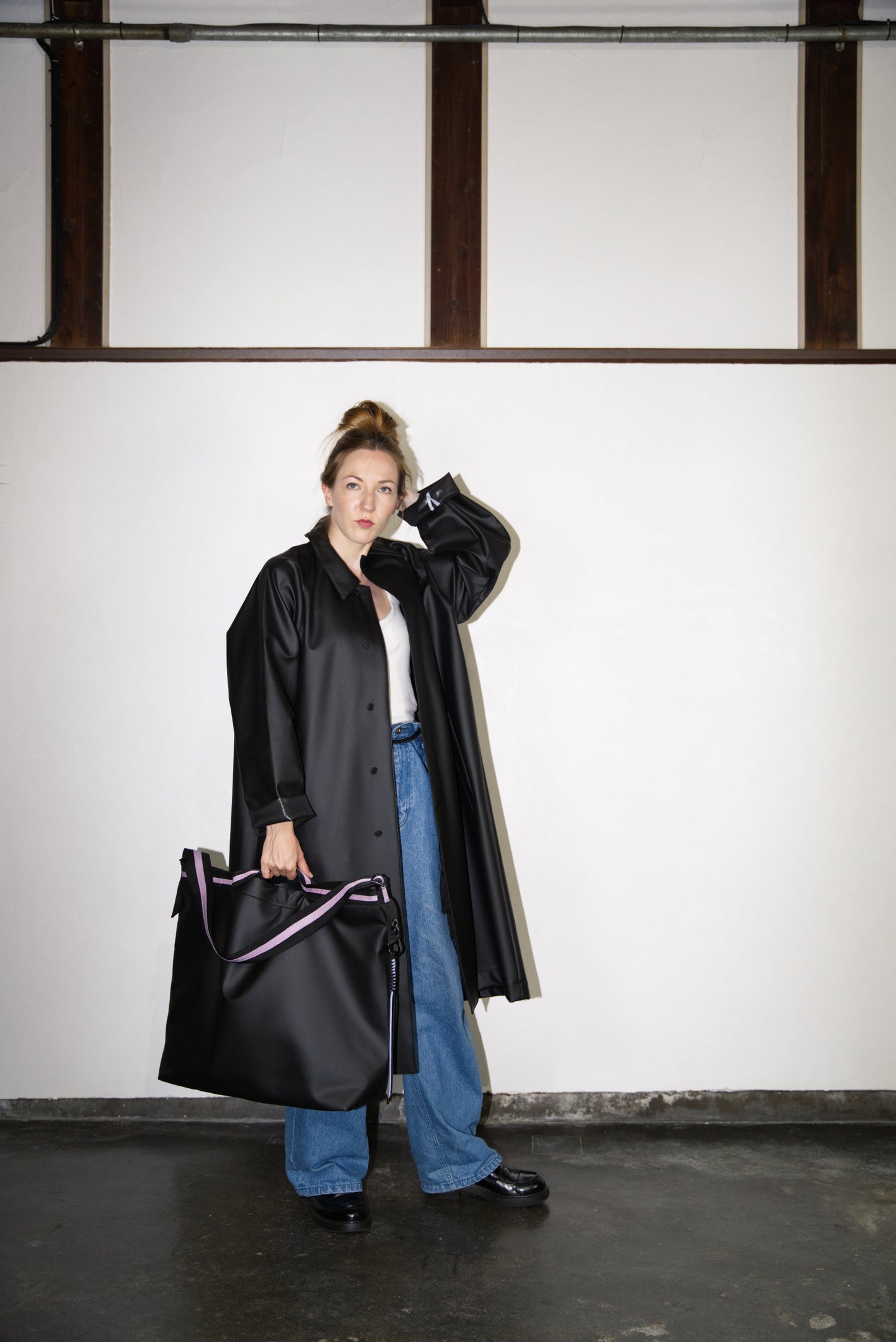 female model carrying the Large Helmet Bag in Cactus Leather
