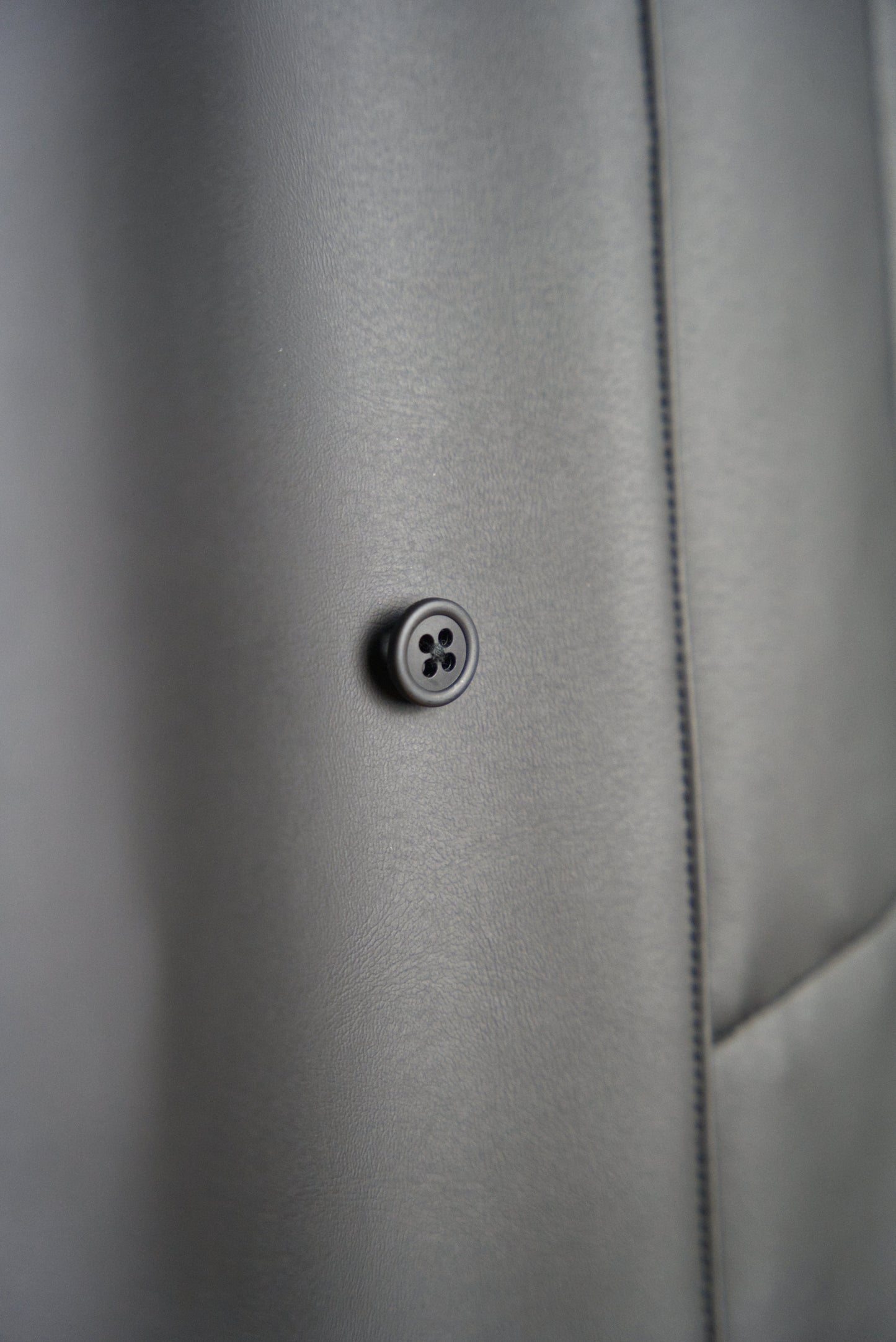 one of the plant-based buttons on the matt black bal collar coat in cactus leather