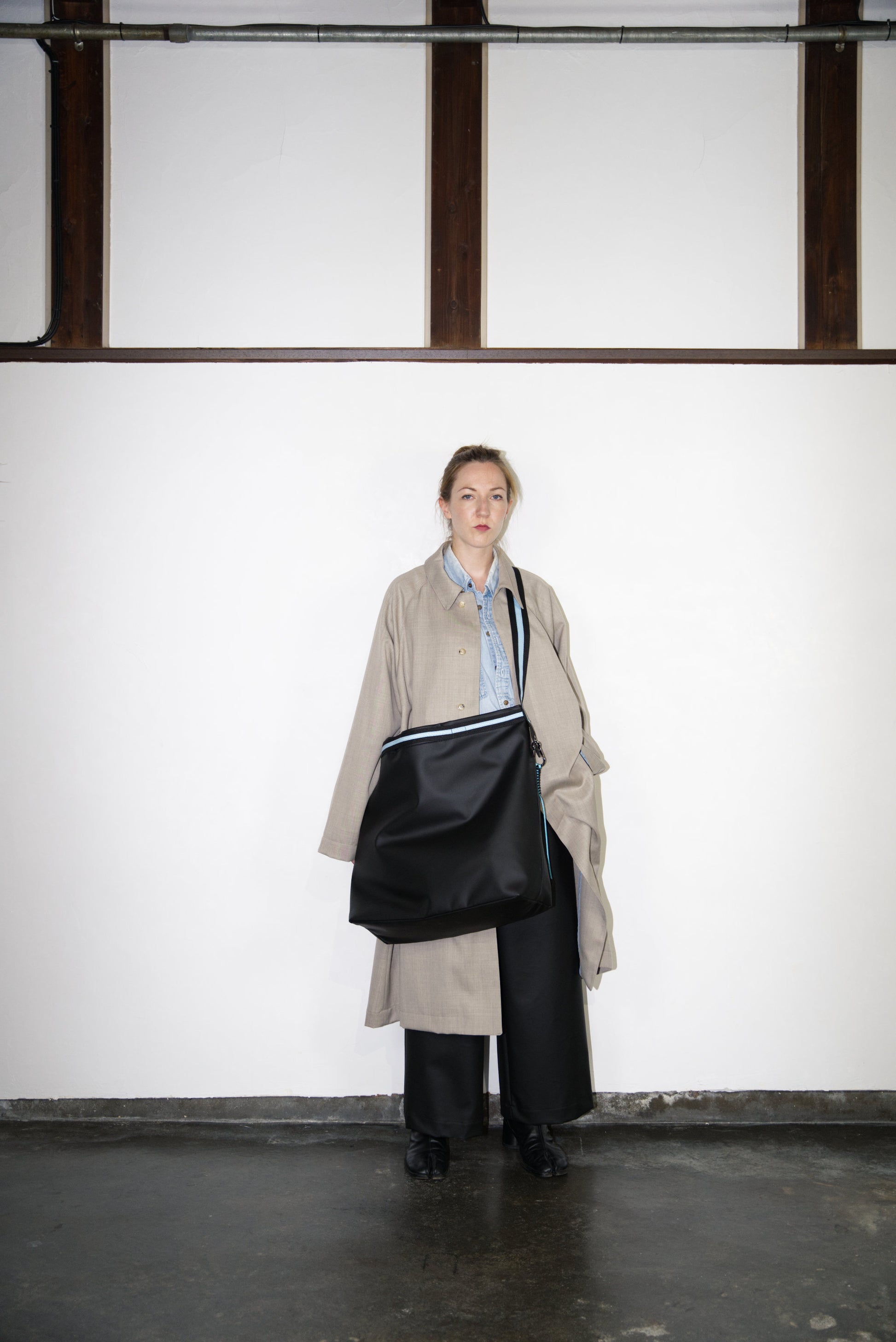 female model carrying the Large Helmet Bag in Cactus Leather