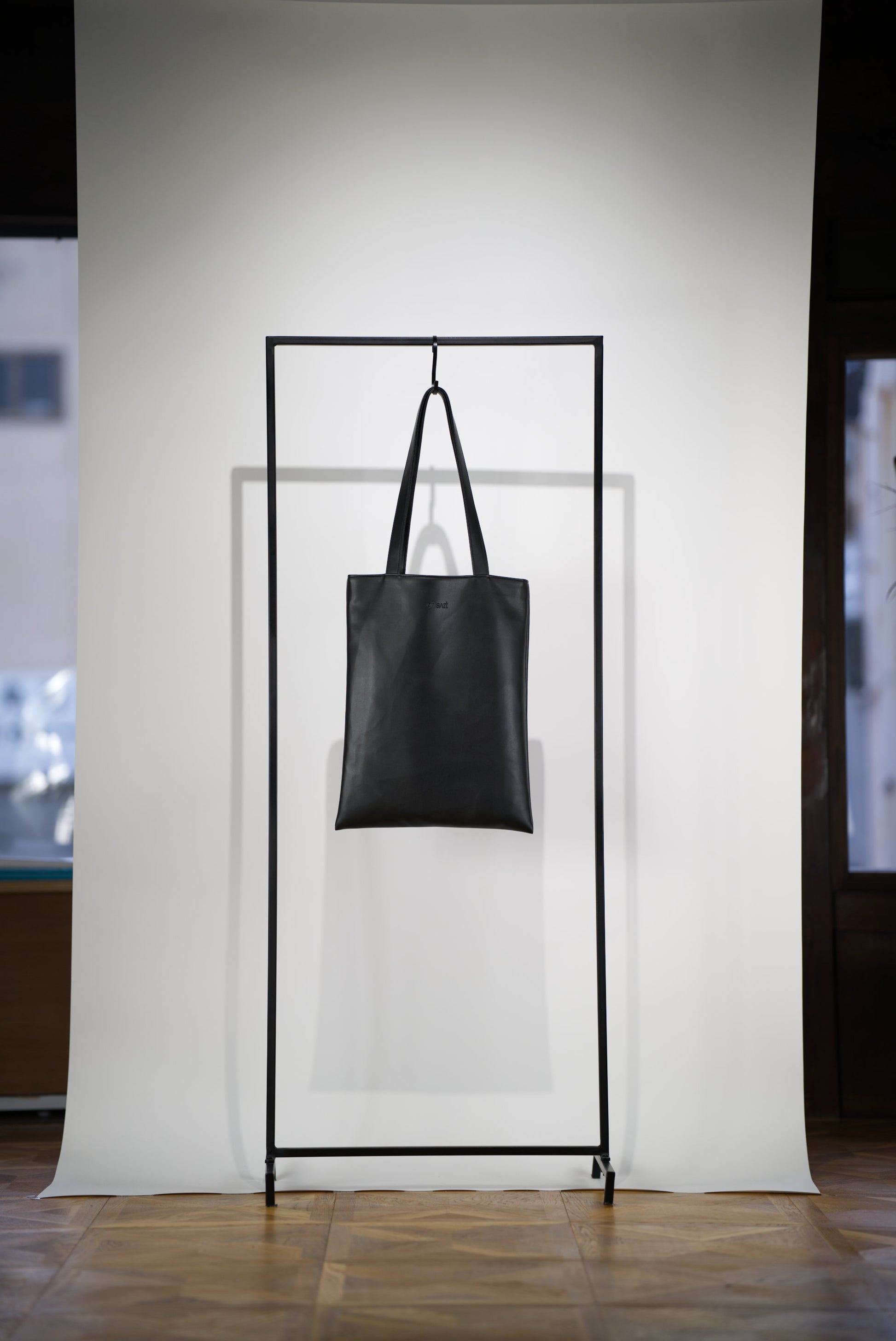 VOID Tote Bag in Cactus Leather hanging on a rack